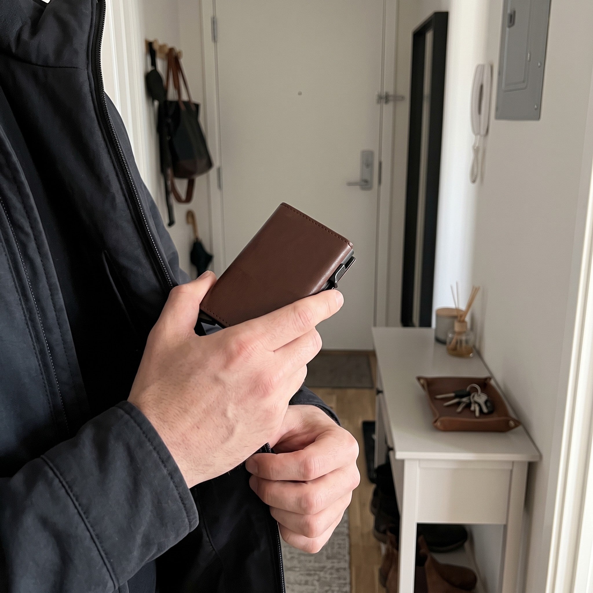 Brown wallet going into a jacket front pocket
