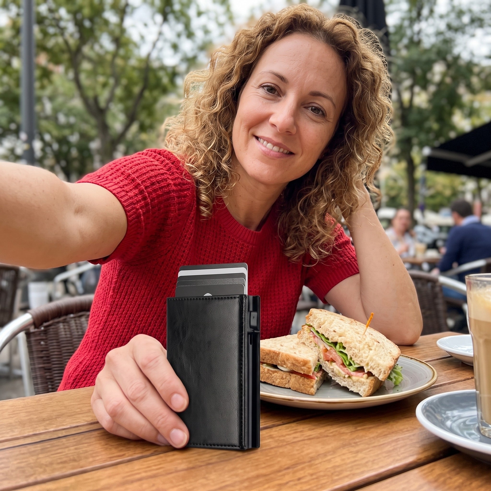 Woman with black wallet taking a cafe selfie